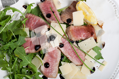 Image of Beef on arugula salad and parmesan