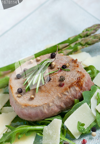 Image of Delicious Beef on arugula salad and parmesan