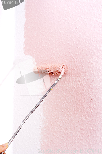 Image of painting a wall in pink