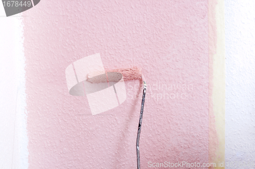 Image of painting a wall in pink