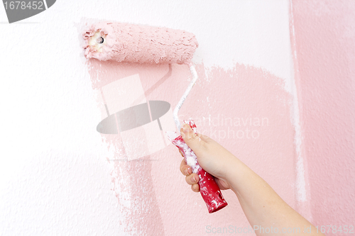 Image of painting a wall in pink