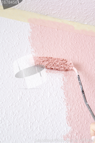 Image of painting a wall in pink