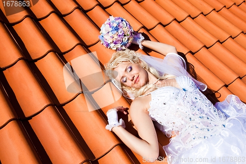 Image of beautiful bride on tile roof