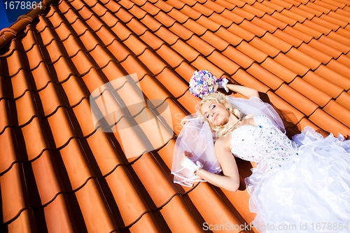 Image of beautiful bride on tile roof