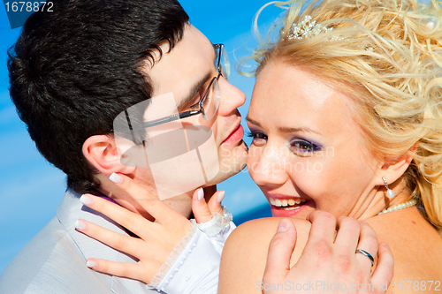 Image of happy groom and bride on a sea coast