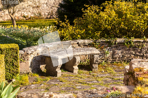 Image of Old stone carved bench in garden