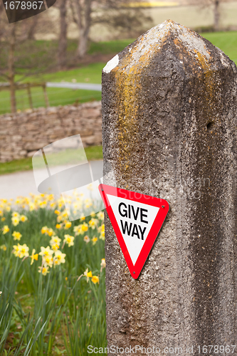 Image of Give way sign on old stone gatepost