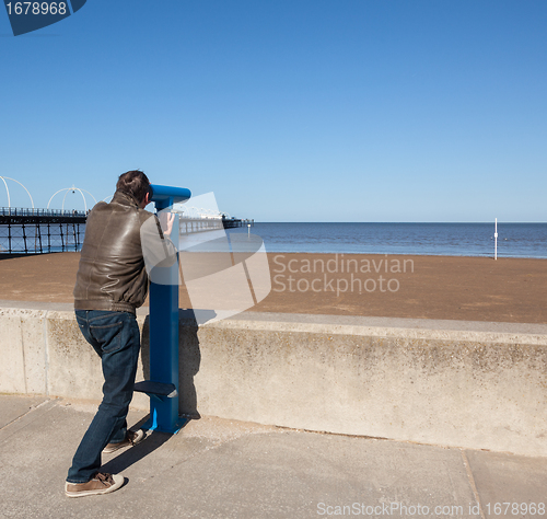 Image of Senior man looking out over beach at Southport