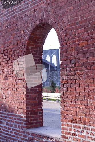 Image of Brooklyn Bridge framed through brick window