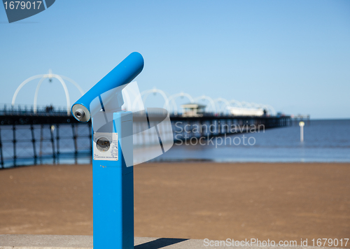 Image of Blue telescope by blurred Southport pier