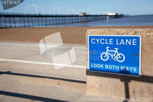 Image of Blue cycle path lane sign by beach