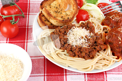 Image of Spaghetti dinner with meatballs, sauce and salad.