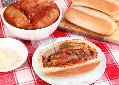 Image of Sausage sub with peppers, onions and tomato sauce.
