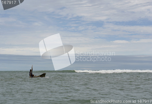 Image of the latin man in boat on pacific