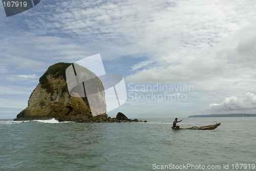 Image of the latin man in boat on pacific