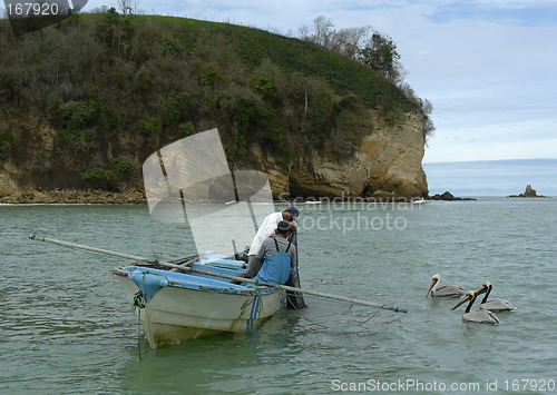 Image of fishermen and three pelicans on pacific ocean