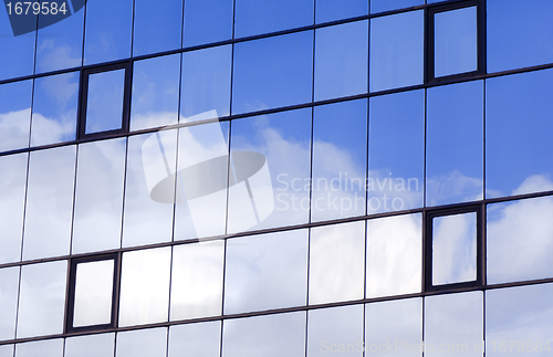 Image of Sky and clouds reflected in a modern building glass facade