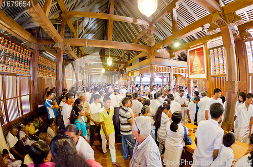 Image of crowd of worshipers and tourists at the entrance to the room wit