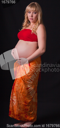 Image of art portrait of pregnant woman on a black background