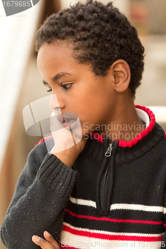 Image of Portrait of an Ethiopian boy resting his chin on his hands