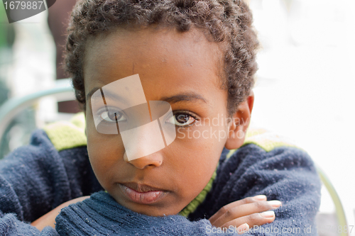 Image of Portrait of an Ethiopian boy resting his chin on his hands