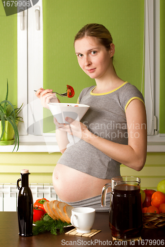 Image of Pregnant Woman On Kitchen