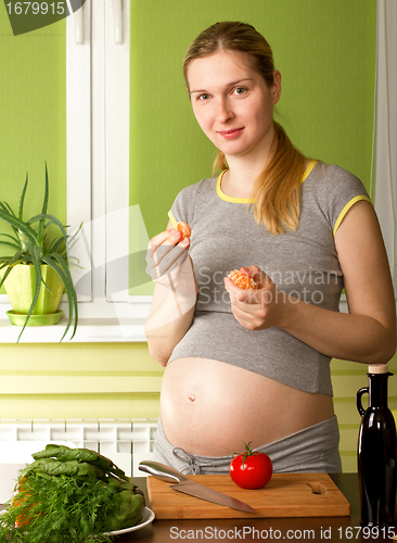 Image of Pregnant Woman On Kitchen