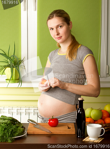 Image of Pregnant Woman On Kitchen