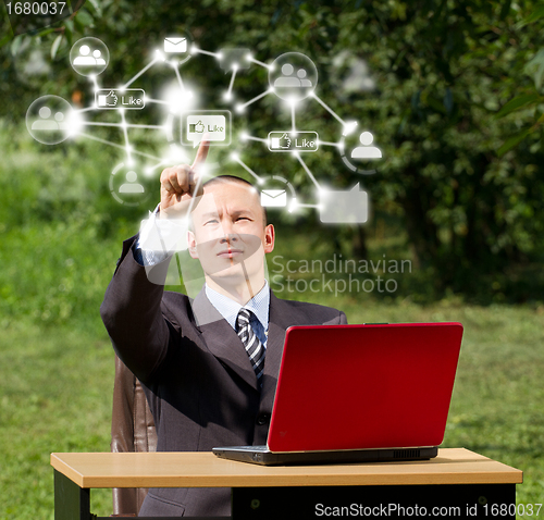 Image of Man with Laptop Working Outdoors in Social Network