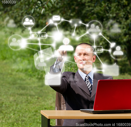 Image of Man with Laptop Working Outdoors in Social Network