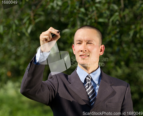 Image of Businessman Writing Something Outdoors