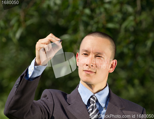 Image of Businessman Writing Something Outdoors