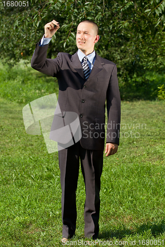 Image of Businessman Writing Something Outdoors