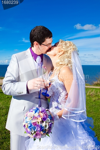 Image of  happy groom and bride on a sea coast