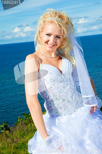 Image of beautiful bride on a sea coast