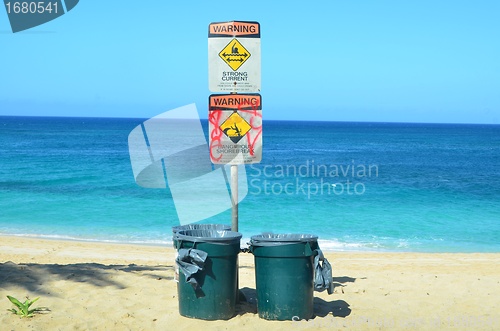 Image of Beach hazard signs and dustbins
