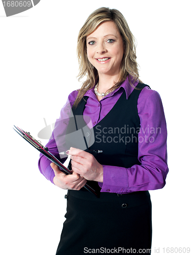 Image of Portrait of experienced lady writing on clipboard