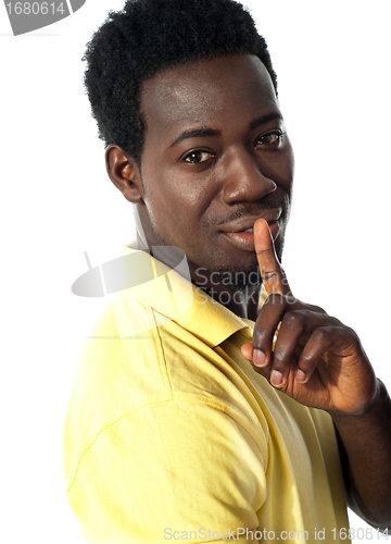 Image of Handsome young guy gesturing silence