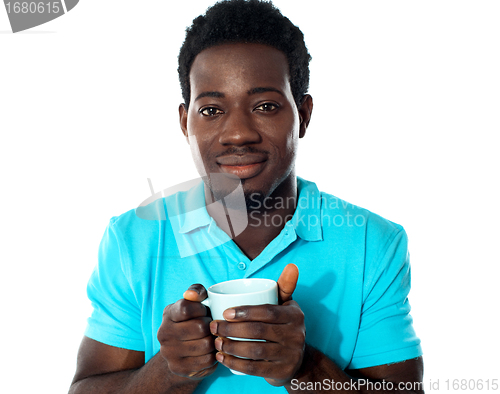 Image of African guy holding coffee mug