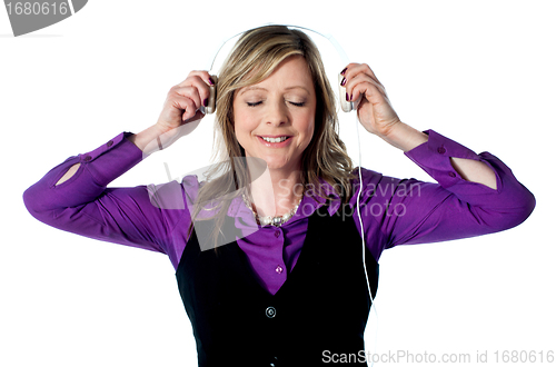 Image of Lady enjoying music through headphones