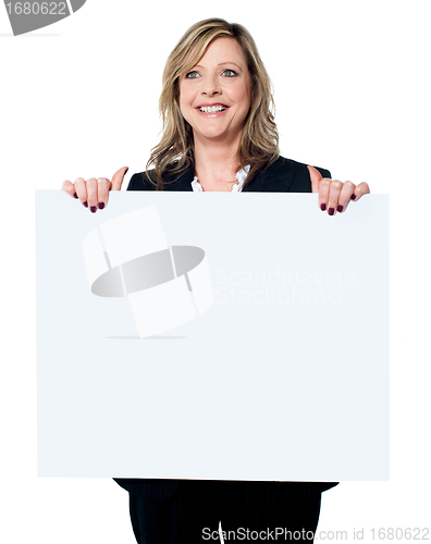 Image of Female business professional holding blank billboard
