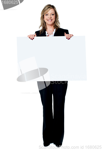 Image of Senior beautiful woman smiling showing blank white placard