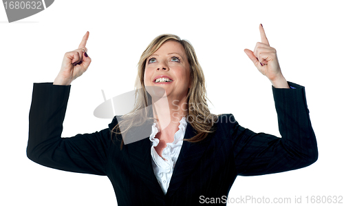 Image of Female executive pointing upwards