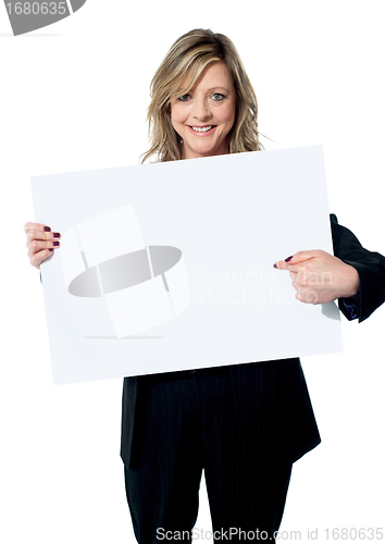 Image of Beautiful woman pointing at the blank billboard