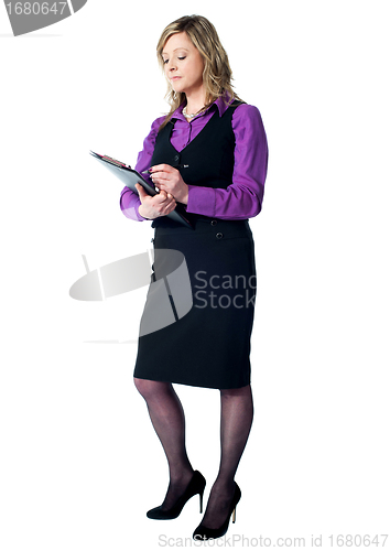 Image of Female secretary writing on clipboard