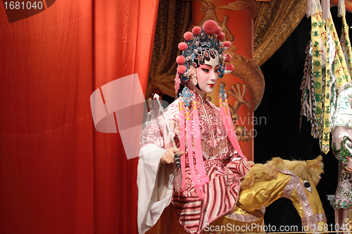 Image of chinese opera dummy and red cloth as text space ,it is a toy,not