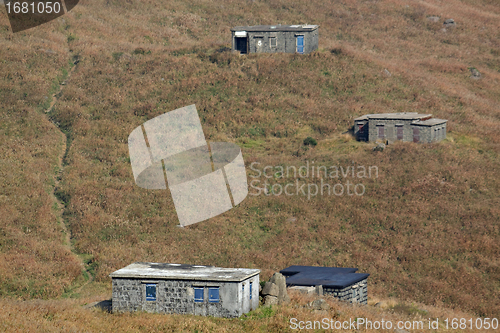 Image of old stone house with grass on the mountain 