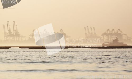 Image of container cranes on a foggy morning