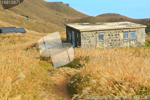 Image of old stone house with grass on the mountain 