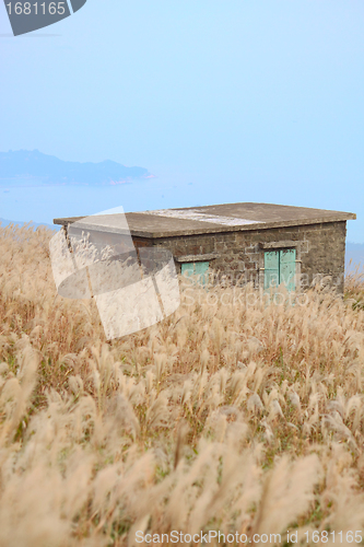 Image of old stone house with grass on the mountain 